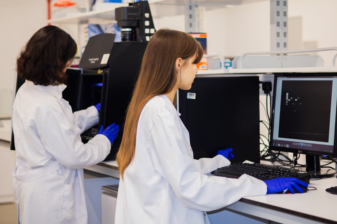 Two graduate scientists working at computers in a laboratory