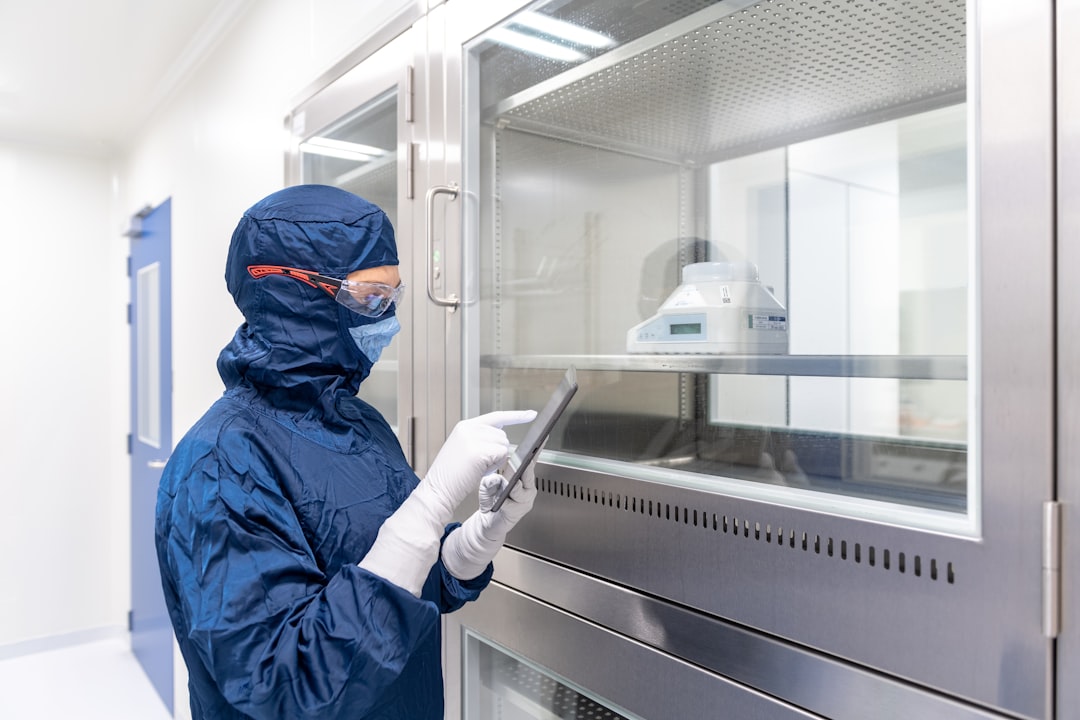Laboratory technician monitoring a pharmaceutical laboratory environment