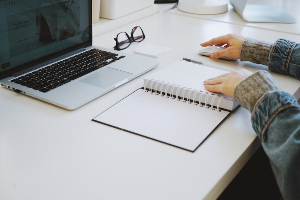 Person writing notes while planning an application